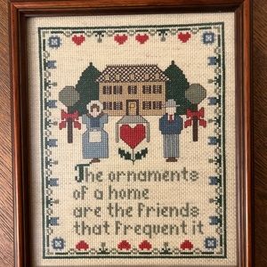 Vintage cross stitched cottage core picture of a man and woman.